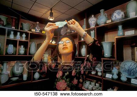 Pottery shop, woman looking at celadon porcelain. Arita village. Kyushu island. Japan. View Large Photo Image Stock Photo - Pottery shop, woman looking at celadon porcelain. Arita village. Kyushu island. Japan.. Fotosearch