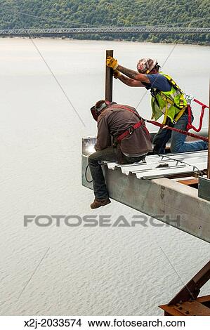Poughkeepsie, New York - Construction workers on the Walkway Over the Hudson, an abandoned railroad bridge over the Hudson River which has been converted to a 1. 28-mile pedestrian walkway and state park. View Large Photo Image Picture - Poughkeepsie, New York - Construction workers on the Walkway Over the Hudson, an abandoned railroad bridge over the Hudson River which has been converted to a 1. 28-mile pedestrian walkway and state park.. Fotosearch