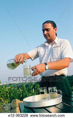 Pouring white wine. Hills of Grinzing Heurigen. Vienna. Austria. View Large Photo Image Stock Photo - Pouring white wine. Hills of Grinzing Heurigen. Vienna. Austria.. Fotosearch