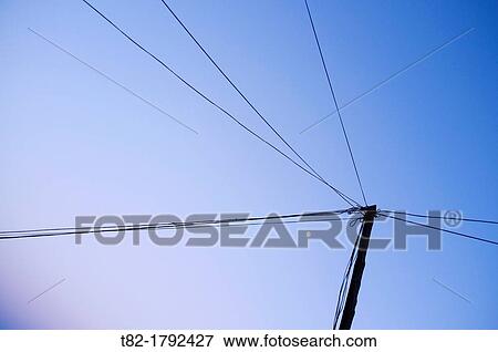 Stock Photo - power lines and moon on blue sky. Fotosearch