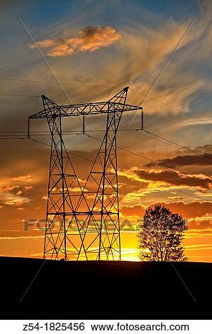 Stock Photograph - Power lines at sunset, back lighting. Fotosearch