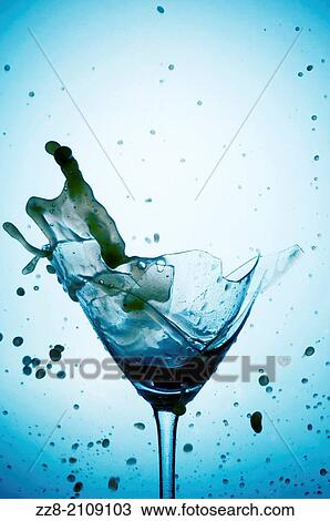 Powerful Splash breaking a martini glass, a conceptual image about alcohol addiction. View Large Photo Image Stock Image - Powerful Splash breaking a martini glass, a conceptual image about alcohol addiction.. Fotosearch
