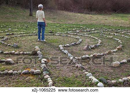 Prairieville, Michigan - A woman stands at the center of a labyrinth at Circle Pines camp The labyrinth is an aid to meditation the spiritualism View Large Photo Image Stock Photography - Prairieville, Michigan - A woman stands at the center of a labyrinth at Circle Pines camp The labyrinth is an aid to meditation the spiritualism. Fotosearch