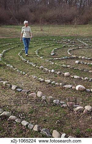 Prairieville, Michigan - A woman walks a labyrinth at Circle Pines camp The labyrinth is an aid to meditation the spiritualism View Large Photo Image Picture - Prairieville, Michigan - A woman walks a labyrinth at Circle Pines camp The labyrinth is an aid to meditation the spiritualism. Fotosearch