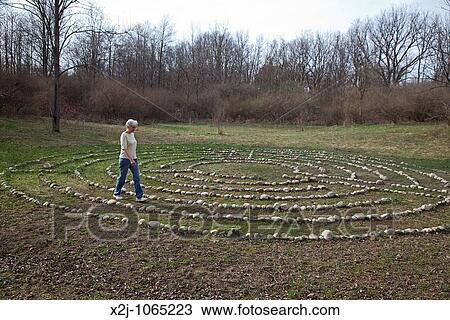 Prairieville, Michigan - A woman walks a labyrinth at Circle Pines camp The labyrinth is an aid to meditation the spiritualism View Large Photo Image Stock Image - Prairieville, Michigan - A woman walks a labyrinth at Circle Pines camp The labyrinth is an aid to meditation the spiritualism. Fotosearch