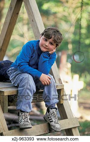 Prairieville, Michigan - Eddie Lonergan sits on a swing set MR View Large Photo Image Stock Image - Prairieville, Michigan - Eddie Lonergan sits on a swing set MR. Fotosearch
