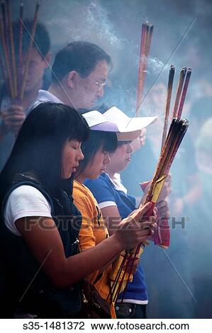 Prayers offer incense to Buddha in Yuantong Temple the famous Buddhist temple build during Tang Dynasty Kunming China. View Large Photo Image Stock Image - Prayers offer incense to Buddha in Yuantong Temple the famous Buddhist temple build during Tang Dynasty Kunming China.. Fotosearch