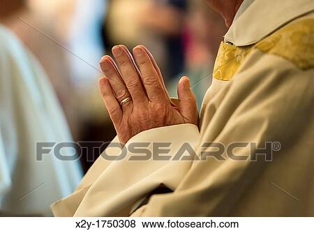 Praying hands of a priest View Large Photo Image Stock Photo - Praying hands of a priest. Fotosearch