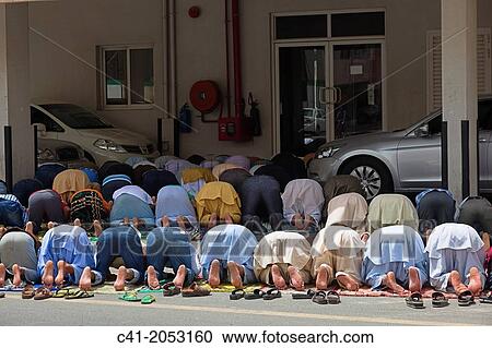 Praying in the street. Dubai. UAE. View Large Photo Image Stock Image - Praying in the street. Dubai. UAE.. Fotosearch
