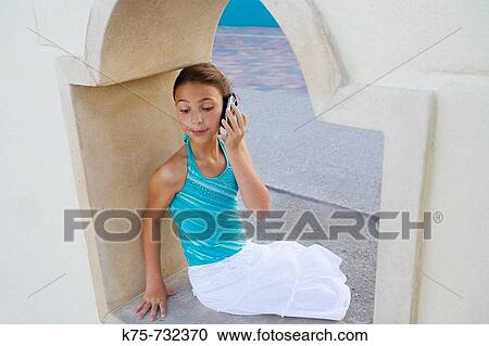 pre-teen talking on cell phone at beach View Large Photo Image Stock Image - pre-teen talking on cell phone at beach. Fotosearch