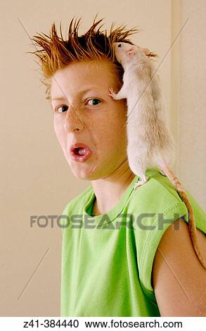 Stock Image - Pre-teenager and white rat. Fotosearch