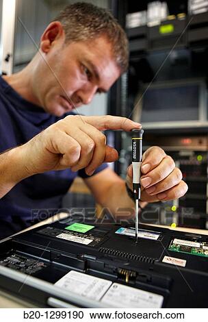 Stock Image - Precision screwdriver, computer maintenance. Fotosearch