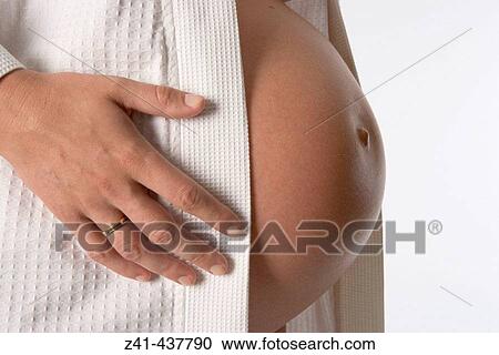 Pregnant belly with hand View Large Photo Image Stock Image - Pregnant belly with hand. Fotosearch