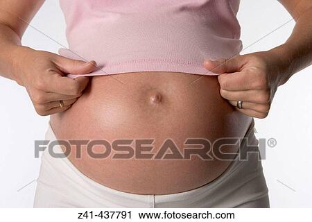 Pregnant belly with hands View Large Photo Image Stock Image - Pregnant belly with hands. Fotosearch