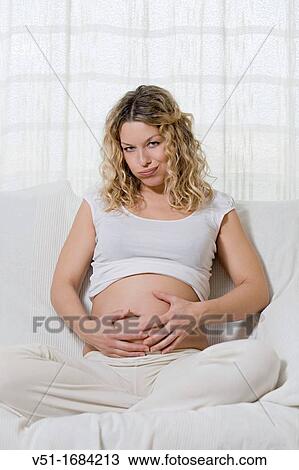 Pregnant fatigued woman on the couch View Large Photo Image Stock Image - Pregnant fatigued woman on the couch. Fotosearch