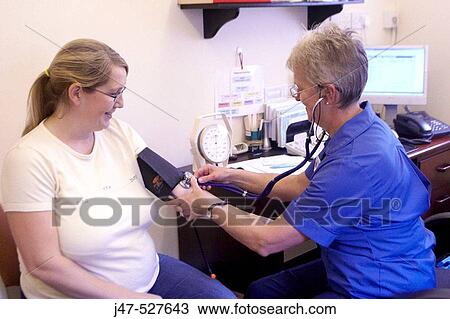 pregnant lady at the doctors having her pre natal checkup, nurse taking her blood pressure View Large Photo Image Stock Image - pregnant lady at the doctors having her pre natal checkup, nurse taking her blood pressure. Fotosearch