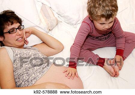 Pregnant mother and three year old boy View Large Photo Image Stock Photo - Pregnant mother and three year old boy. Fotosearch