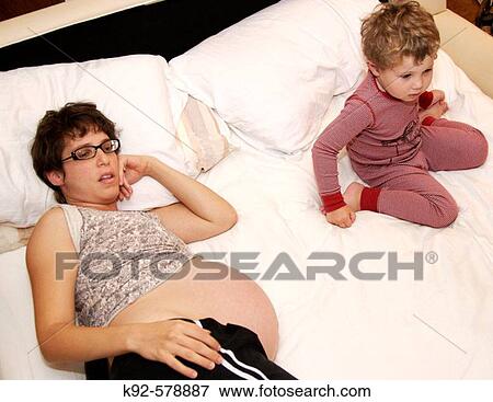 Pregnant mother with three year old boy View Large Photo Image Stock Photo - Pregnant mother with three year old boy. Fotosearch