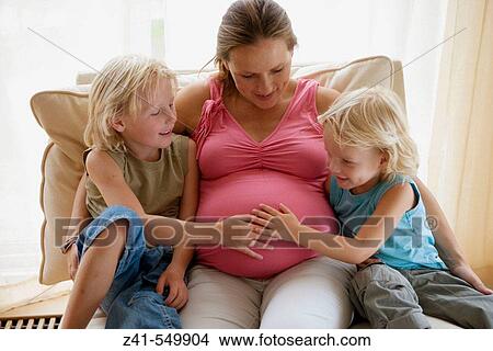 Pregnant mother with two sons. View Large Photo Image Picture - Pregnant mother with two sons.. Fotosearch