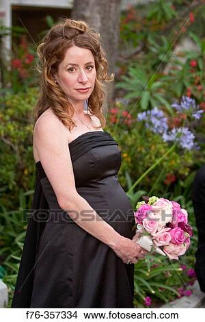 Pregnant woman at wedding. View Large Photo Image Picture - Pregnant woman at wedding.. Fotosearch