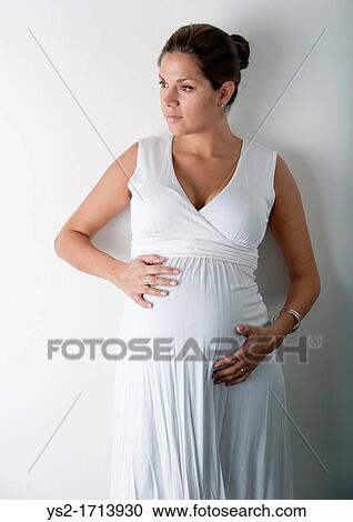 Pregnant woman holding hands on her stomach View Large Photo Image Stock Image - Pregnant woman holding hands on her stomach. Fotosearch