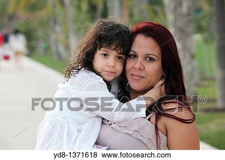Pregnant woman holding her child in Miami Beach, Florida, USA View Large Photo Image Stock Photo - Pregnant woman holding her child in Miami Beach, Florida, USA. Fotosearch