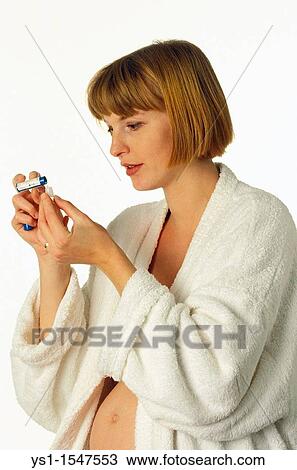 Pregnant Woman in Bath robe taking Homeopathic Pills against White Background View Large Photo Image Stock Image - Pregnant Woman in Bath robe taking Homeopathic Pills against White Background. Fotosearch