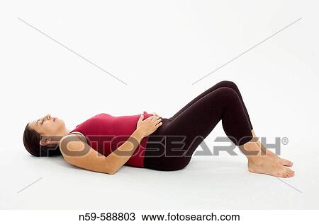 Stock Image - Pregnant woman in exercise clothing in relaxed posture during workout.. Fotosearch