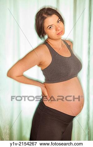 Pregnant woman in front of a window. View Large Photo Image Stock Photo - Pregnant woman in front of a window.. Fotosearch