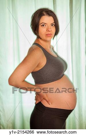 Pregnant woman in front of a window. View Large Photo Image Stock Photograph - Pregnant woman in front of a window.. Fotosearch