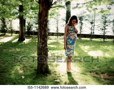 Pregnant woman in park View Large Photo Image Stock Photo - Pregnant woman in park. Fotosearch