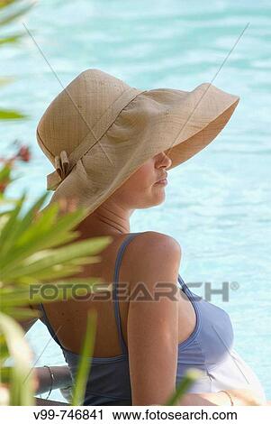 Stock Image - Pregnant woman in swimming pool. Fotosearch