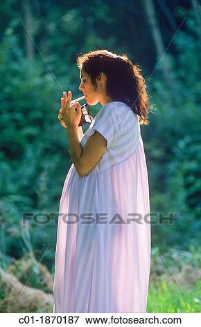 Pregnant woman lighting a cigarette View Large Photo Image Stock Photo - Pregnant woman lighting a cigarette. Fotosearch