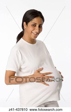 Stock Image - Pregnant woman looking into the camera. Fotosearch