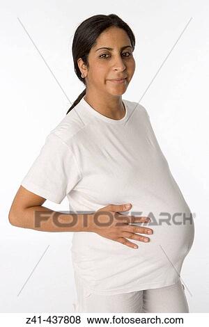 Stock Photo - Pregnant woman looking into the camera. Fotosearch