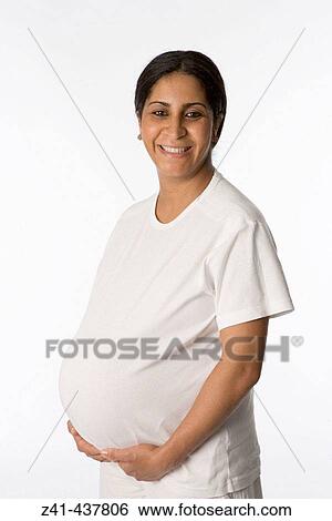 Stock Photograph - Pregnant woman looking into the camera. Fotosearch