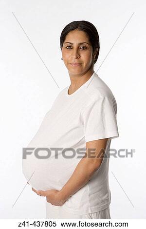 Pregnant woman looking into the camera View Large Photo Image Stock Photography - Pregnant woman looking into the camera. Fotosearch