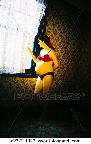Pregnant woman looking through the window View Large Photo Image Stock Image - Pregnant woman looking through the window. Fotosearch