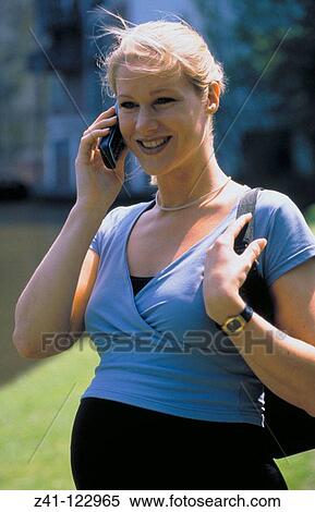 Stock Photography - Pregnant woman on mobile phone. Fotosearch