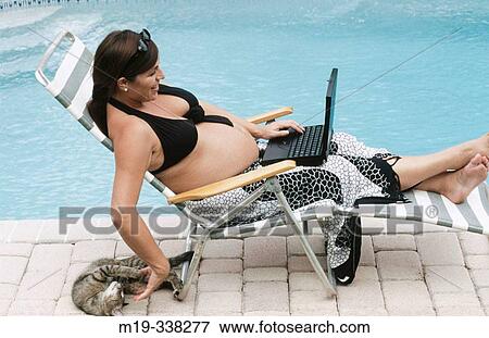pregnant woman poolside with laptop View Large Photo Image Stock Photo - pregnant woman poolside with laptop. Fotosearch