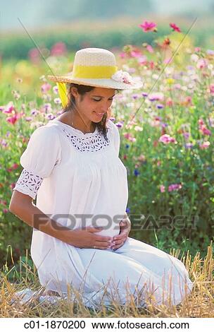 Pregnant woman portrait in flower garden View Large Photo Image Stock Image - Pregnant woman portrait in flower garden. Fotosearch