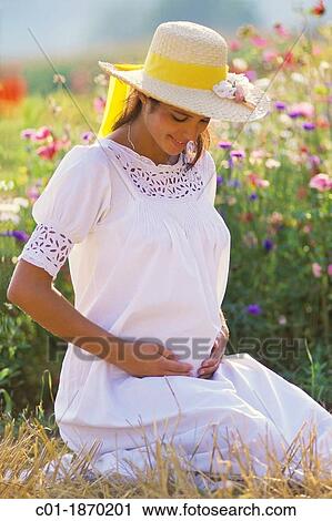 Pregnant woman portrait in flower garden View Large Photo Image Stock Image - Pregnant woman portrait in flower garden. Fotosearch