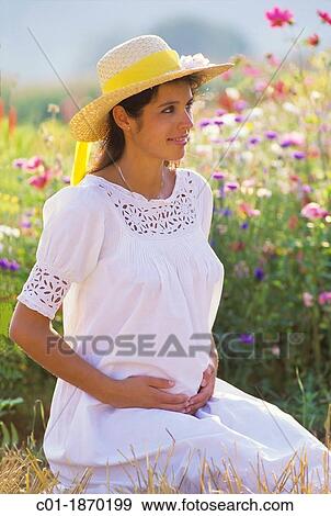 Pregnant woman portrait in flower garden View Large Photo Image Stock Photo - Pregnant woman portrait in flower garden. Fotosearch