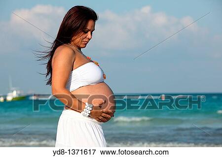 Pregnant woman posing on the beach in Miami Beach, Florida, USA View Large Photo Image Stock Photo - Pregnant woman posing on the beach in Miami Beach, Florida, USA. Fotosearch