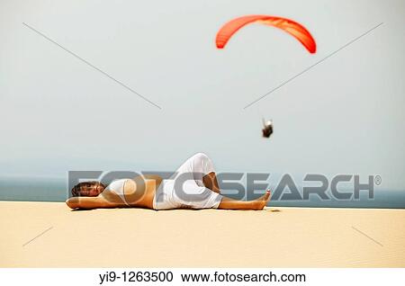 Pregnant woman relaxing on the beach View Large Photo Image Stock Image - Pregnant woman relaxing on the beach. Fotosearch