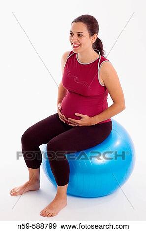 Pregnant woman sitting on an exercise ball. View Large Photo Image Stock Photo - Pregnant woman sitting on an exercise ball.. Fotosearch