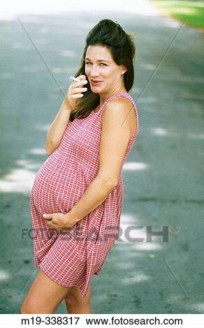 pregnant woman smoking a cigarette View Large Photo Image Stock Photo - pregnant woman smoking a cigarette. Fotosearch