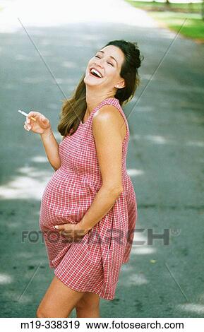 pregnant woman smoking a cigarette View Large Photo Image Stock Photo - pregnant woman smoking a cigarette. Fotosearch
