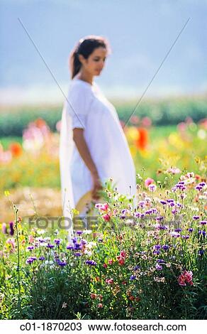 Pregnant woman standing in flower garden View Large Photo Image Stock Image - Pregnant woman standing in flower garden. Fotosearch