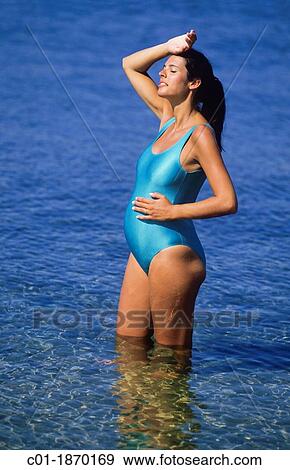 Pregnant woman standing in sea View Large Photo Image Stock Photo - Pregnant woman standing in sea. Fotosearch